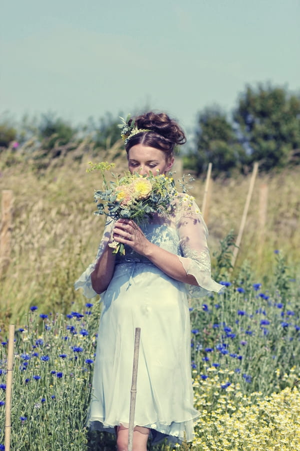 Vintage bride smelling bouquet