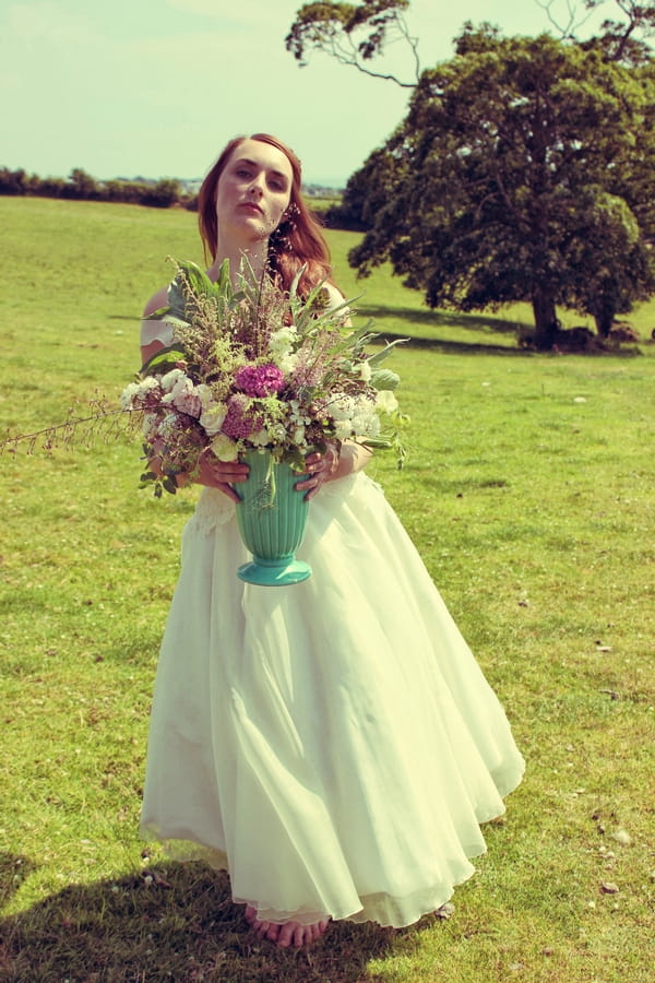 Vintage bride with vase of flowers