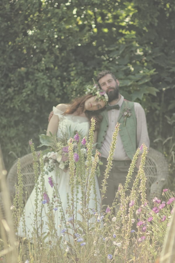 Vintage bride resting head on groom's shoulder