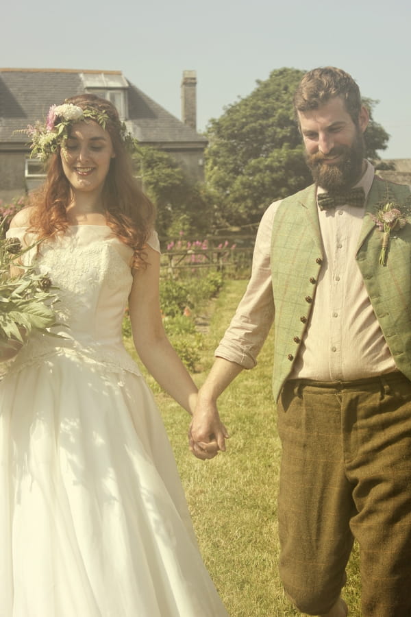 Vintage bride and groom holding hands