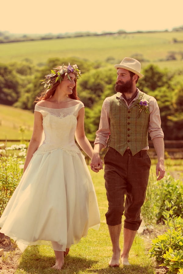 Vintage bride and groom walking holding hands