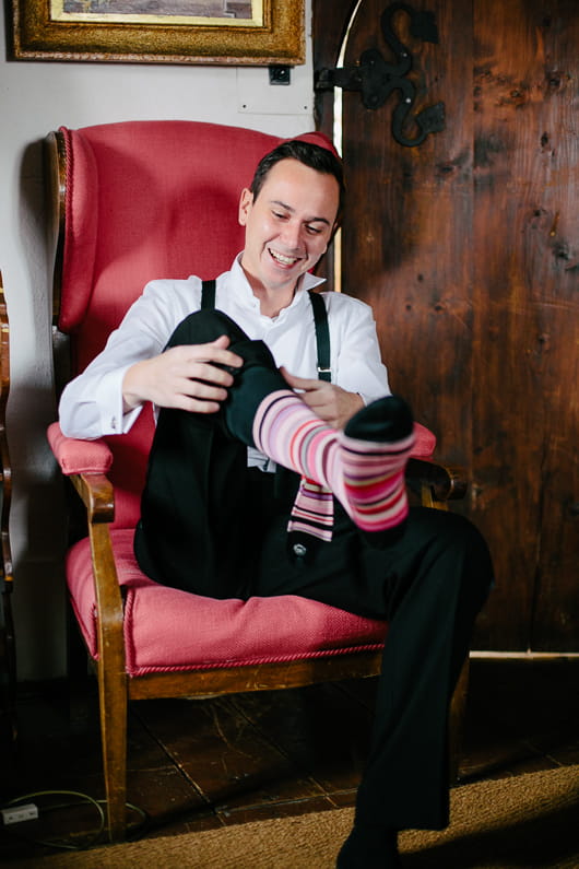 Groom pulling up sock