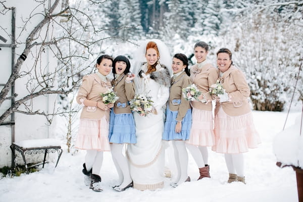 Bride with bridesmaids in snow