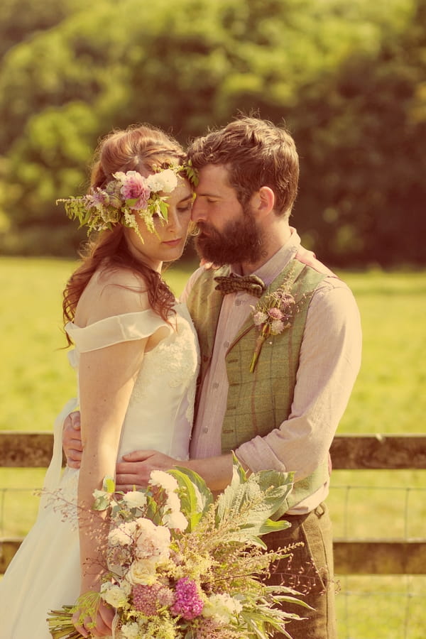 Vintage groom with arms around bride's waist