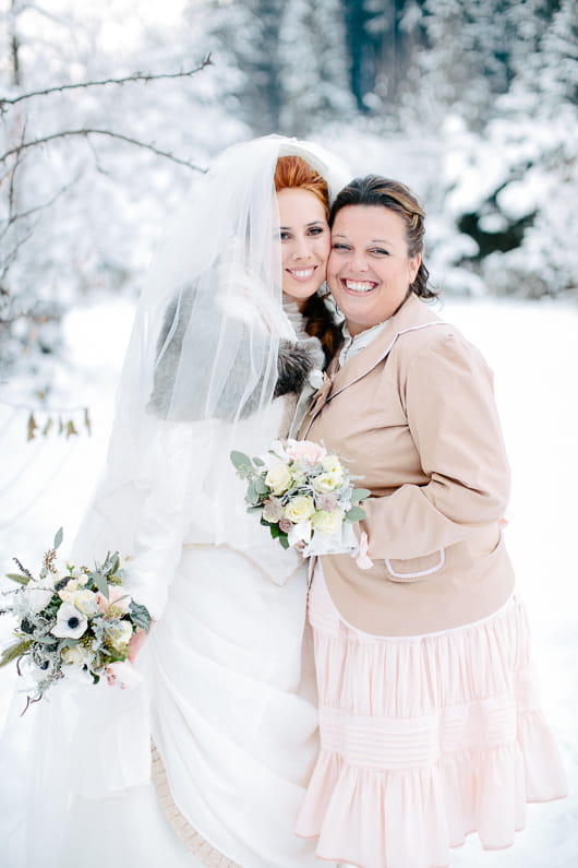 Bride and bridesmaid in snow