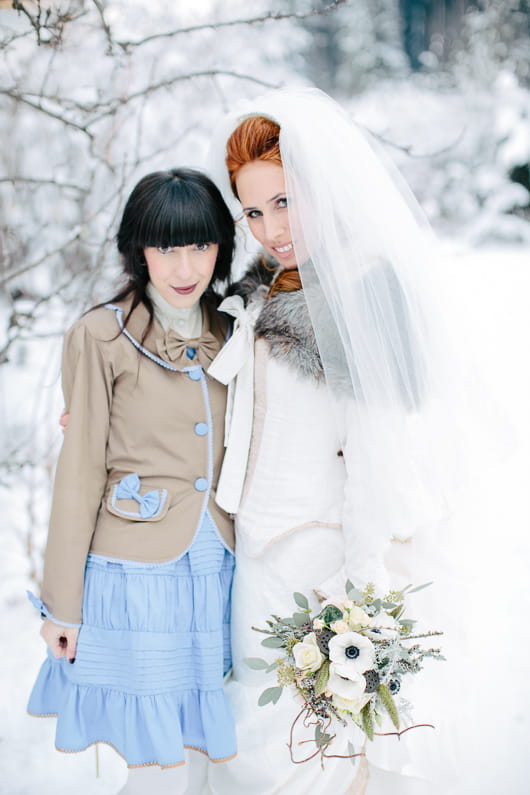 Bride and bridesmaid in snow