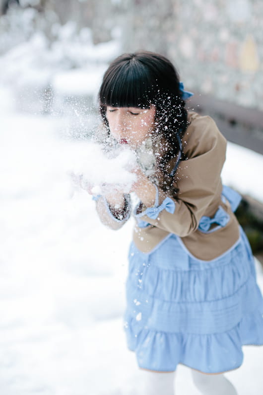 Bridesmaid blowing snow