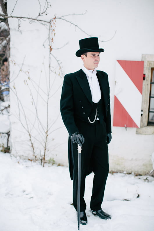 Groom with cane in snow