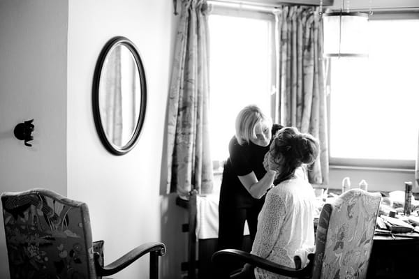 Bride having make-up applied