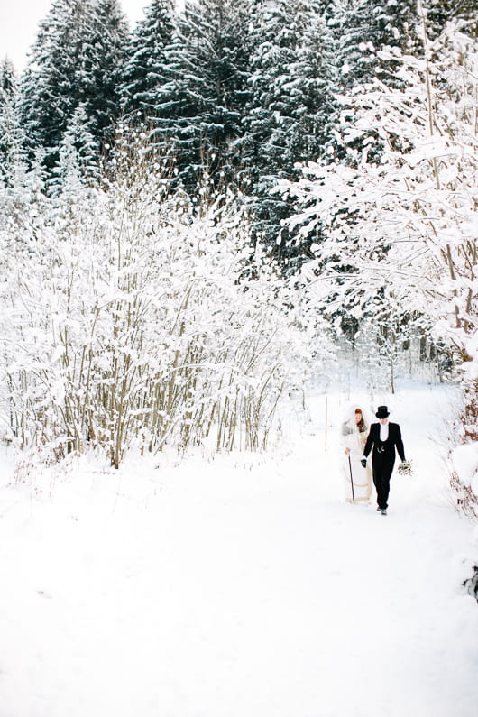 Bride and groom walking in snow