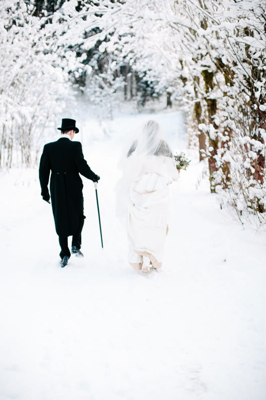 Bride and groom walking in snow