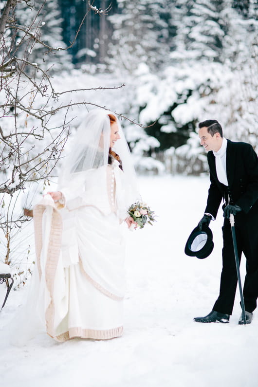 Groom removing hat for bride