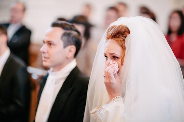 Bride wiping away tear