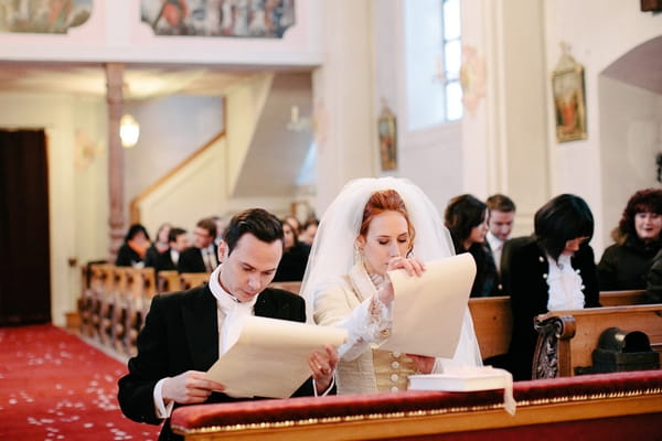 Bride and groom reading order of service