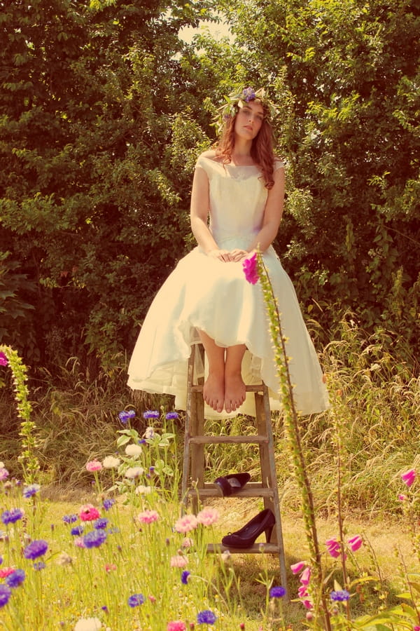 Vintage bride sitting on top of ladder