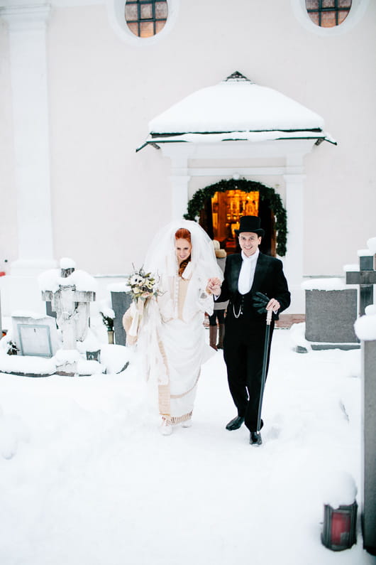 Bride and groom leave church in snow