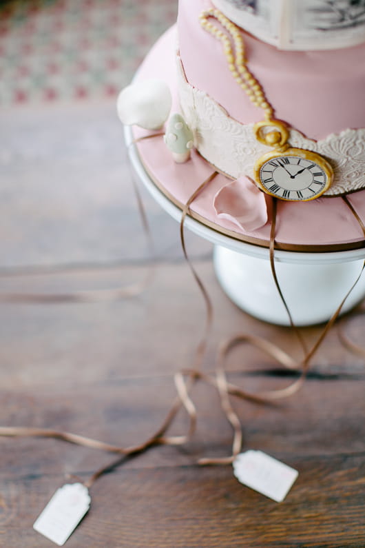 Tags hanging from Alice in Wonderland wedding cake