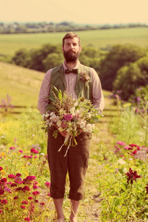 Vintage groom holding bouquet