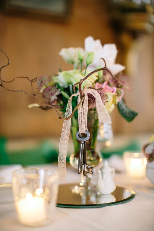 Key hanging from vase of flowers