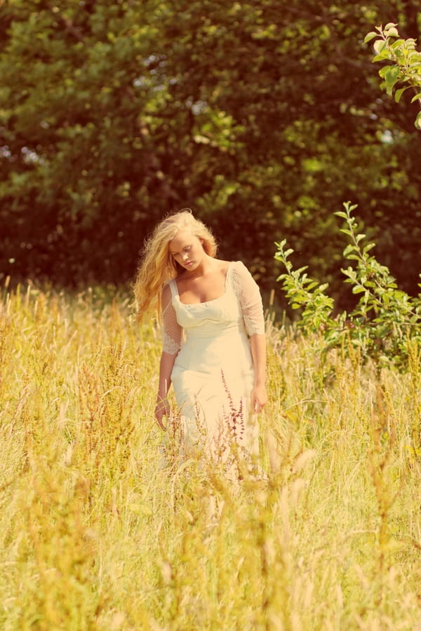 Vintage bride walking through field