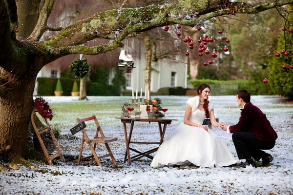 Bride and groom at table outside in snow