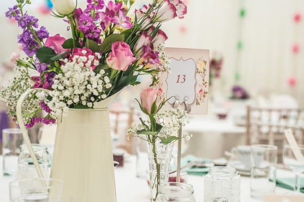 Jug of flowers and wedding table number