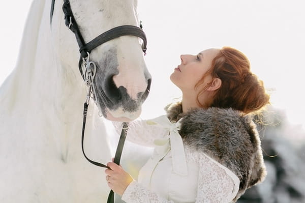 Bride looking up at horse