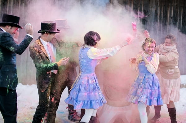 Bridal party throwing holi powder at each other