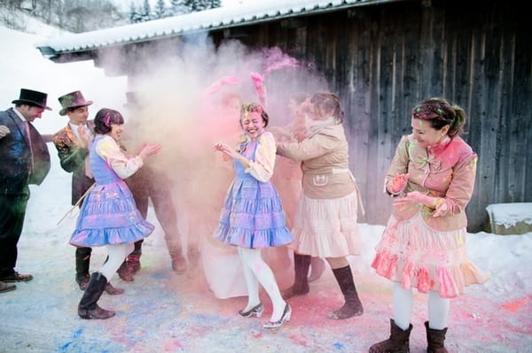 Bridal party throwing holi powder at each other