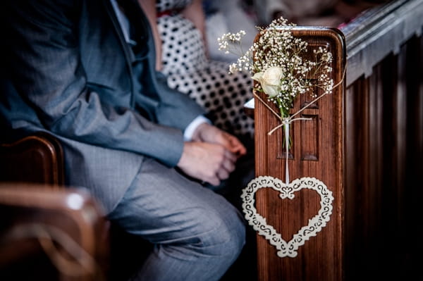 Heart hanging from church pew