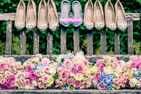 Wedding bouquets and shoes on bench