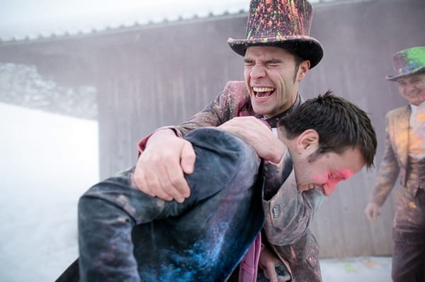 Groomsmen hugging covered in holi powder