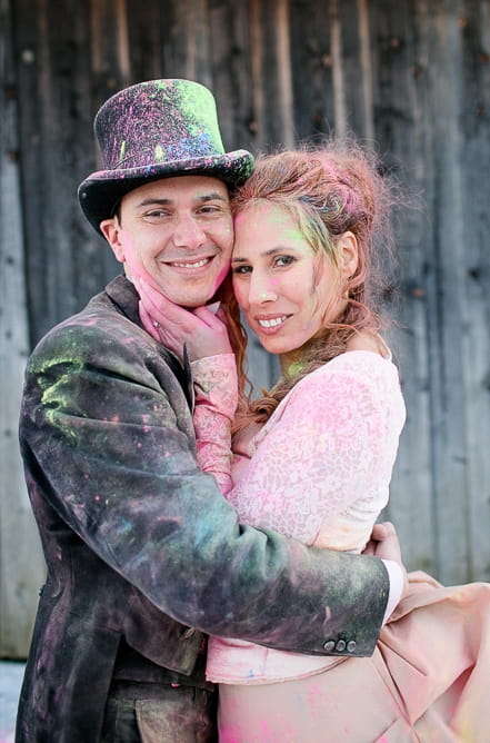 Bride and groom covered in holi powder