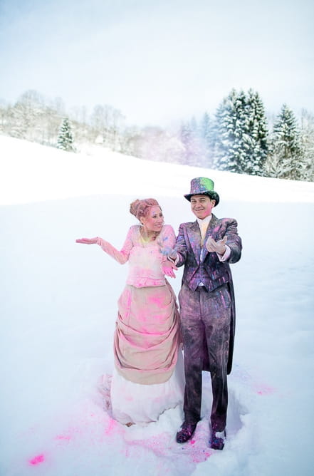 Bride and groom throwing holi powder in the air