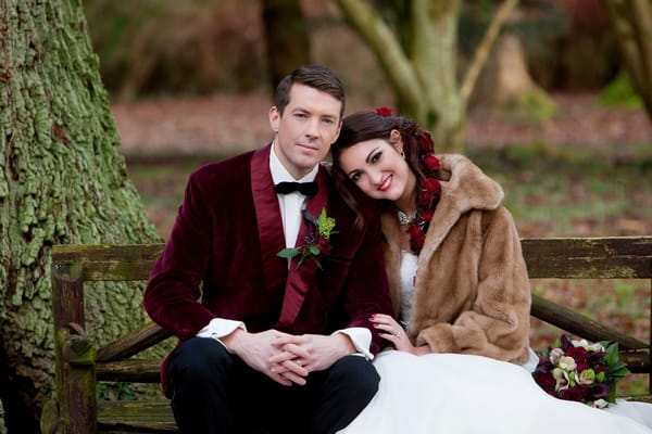 Bride and groom sitting on bench