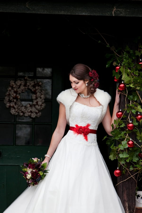 Bride with red bow on wedding dress