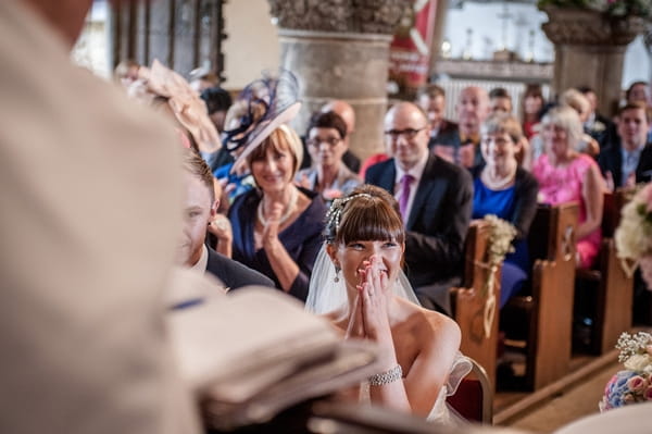 Bride listening to flower girl reading