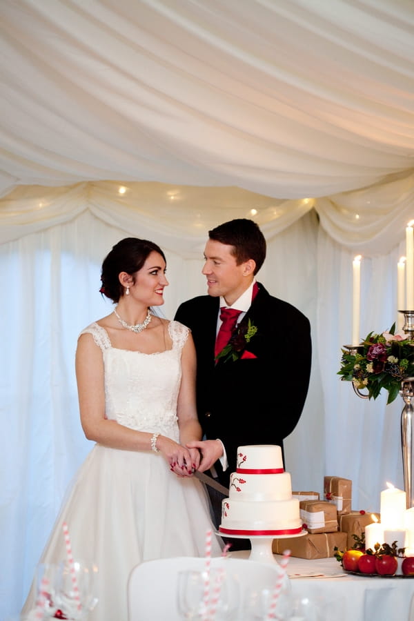 Bride and groom cutting wedding cake