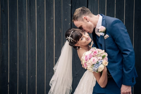 Bride and groom in front of barn doors