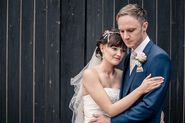 Bride and groom in front of barn doors