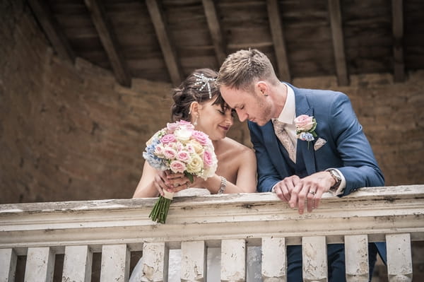 Bride and groom on balcony