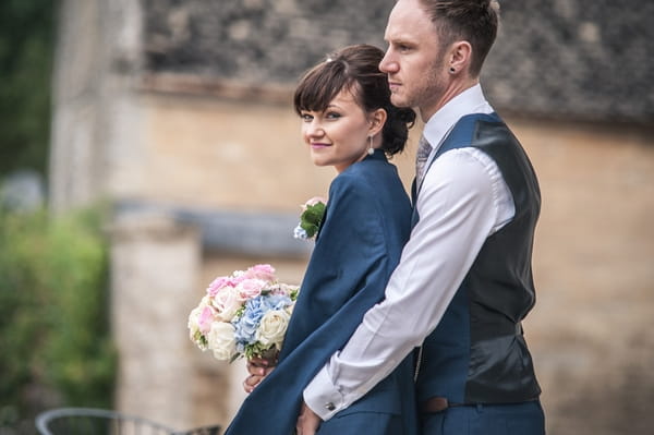 Bride wearing groom's jacket