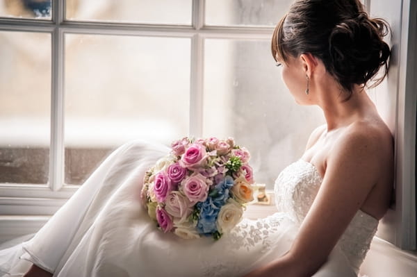 Bride sitting at window