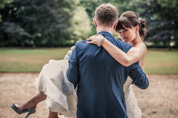 Groom carrying bride