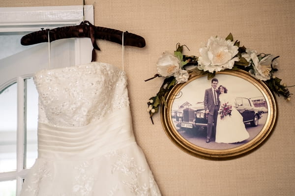 Wedding dress hanging from door