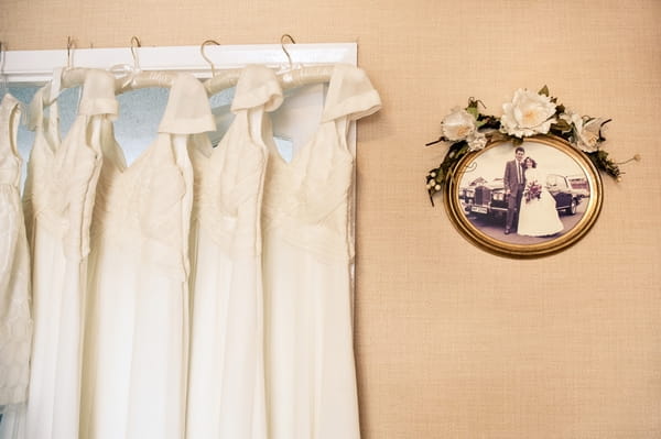 Bridesmaid dresses hanging from door