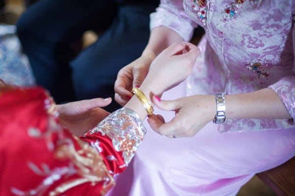 Bride putting bracelet on