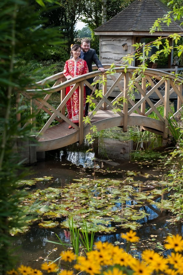 Bride and groom on bridge