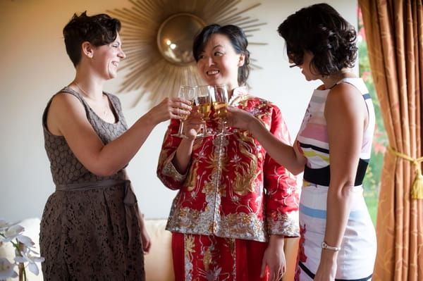 Bride drinking Champagne with bridesmaids