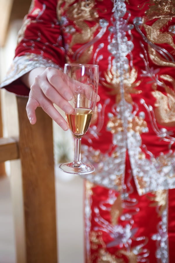 Bride holding glass of Champagne